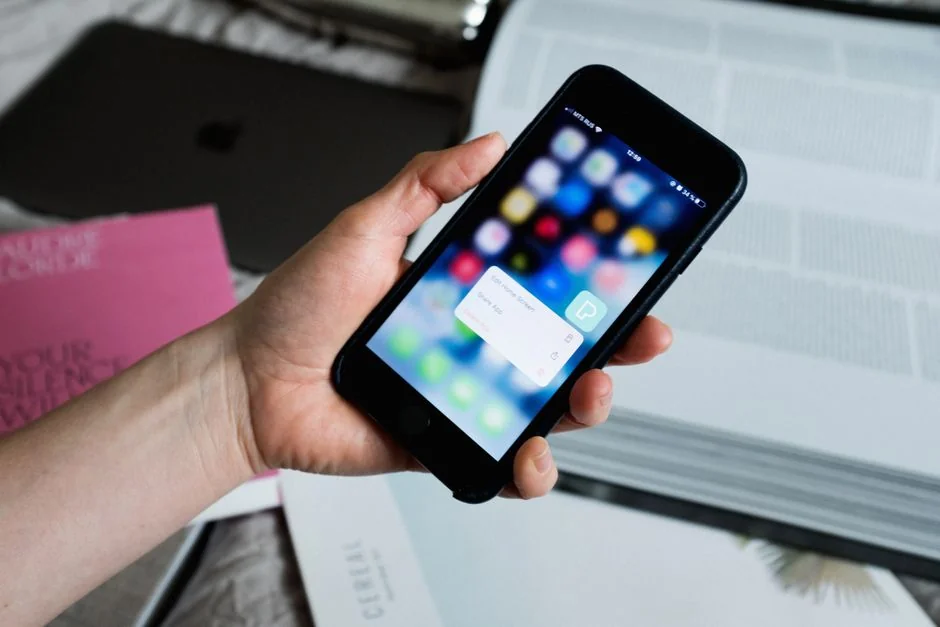 A sleek office desk setup featuring Apple devices: iMac, MacBook, and iPad.